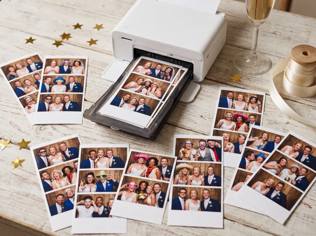 Stampante fotografica da cui escono strisce fotografiche appena stampate